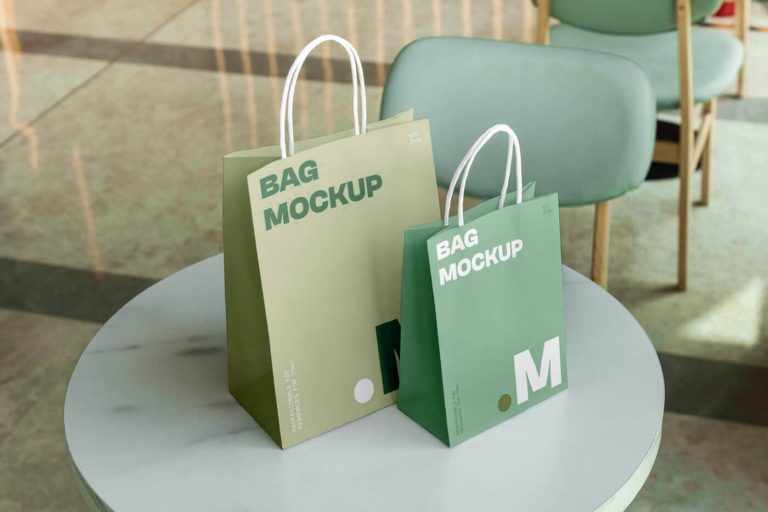 Free two paper shopping bag PSD mockups scene with realistic retail branding presentation on table in modern interior