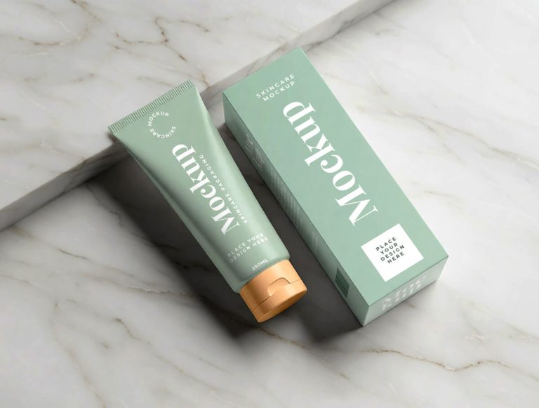 Free skincare cosmetic tube and packaging box mockup top view on marble background