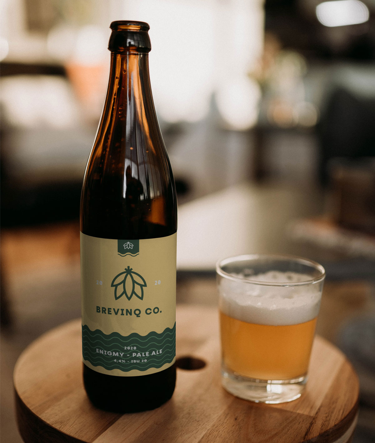 Vichy beer bottle mockup with one full glass beer on a table