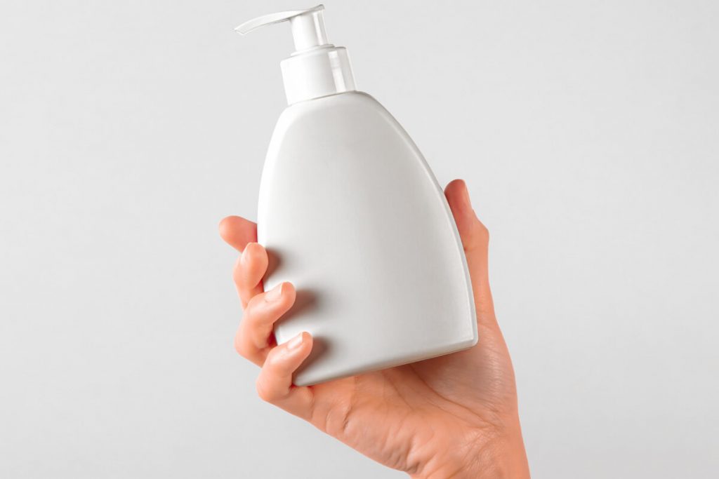 Hand Holding Liquid Cream Pump Bottle Mockup Package Mockups