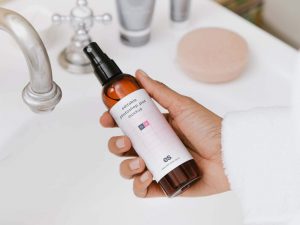 Free Spray Bottle in Hand Mockup PSD