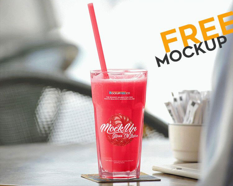 Free Mockup Featuring Big Glass of Juice on a Table at a Cafe