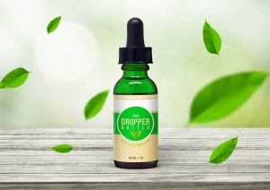 front view of glass dropper bottle on wooden surface mockup 1