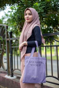 Free Woman in Park Holding Canvas Bag Mockup1