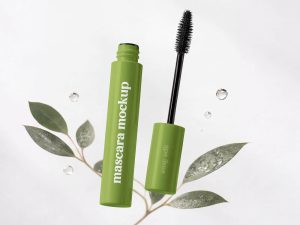 Free mascara mockup PSD with cosmetic packaging design showing open mascara tube and brush for beauty branding presentation